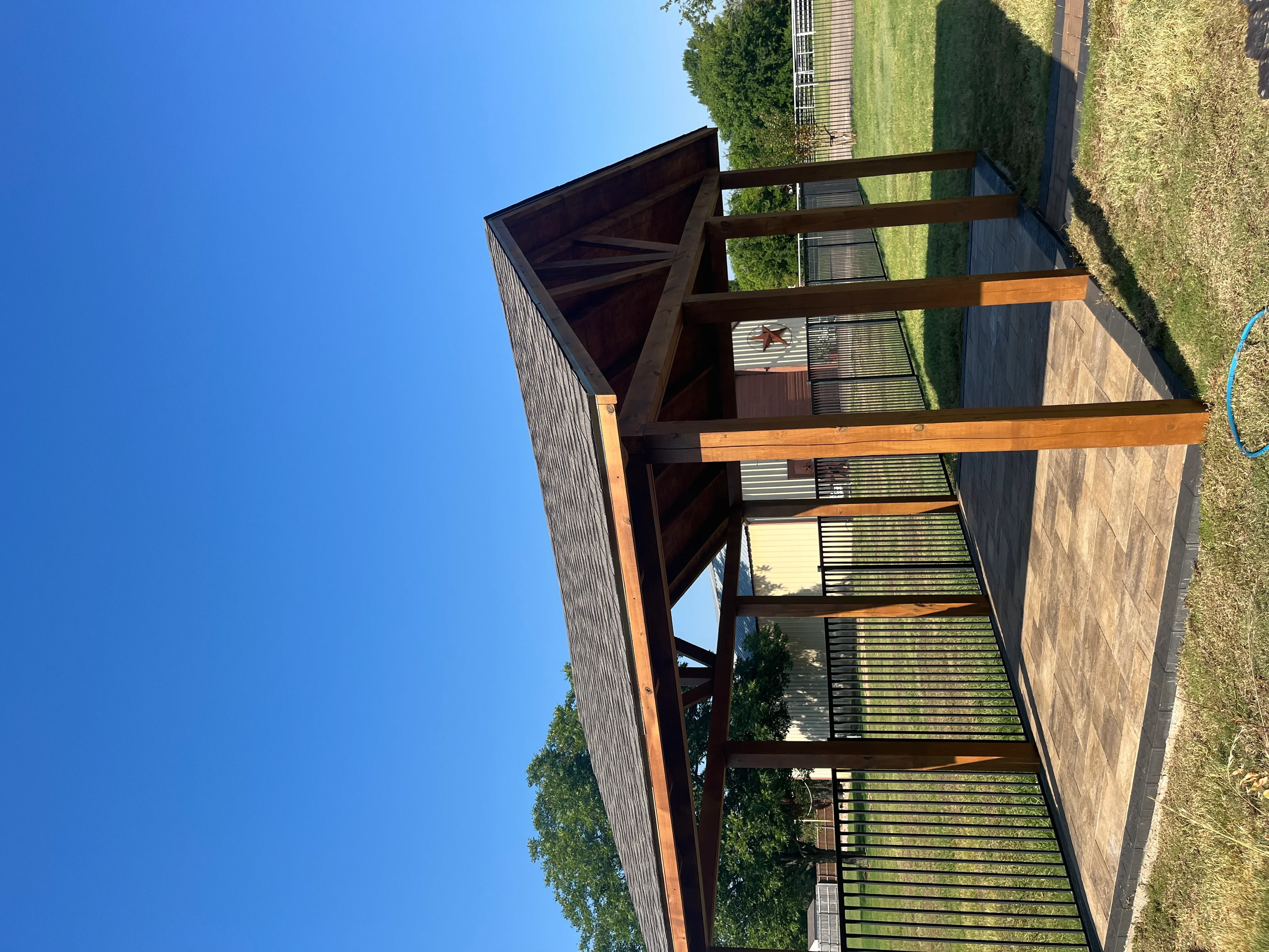 Wood pergola with composite deck, horizontal railings, and shade beams